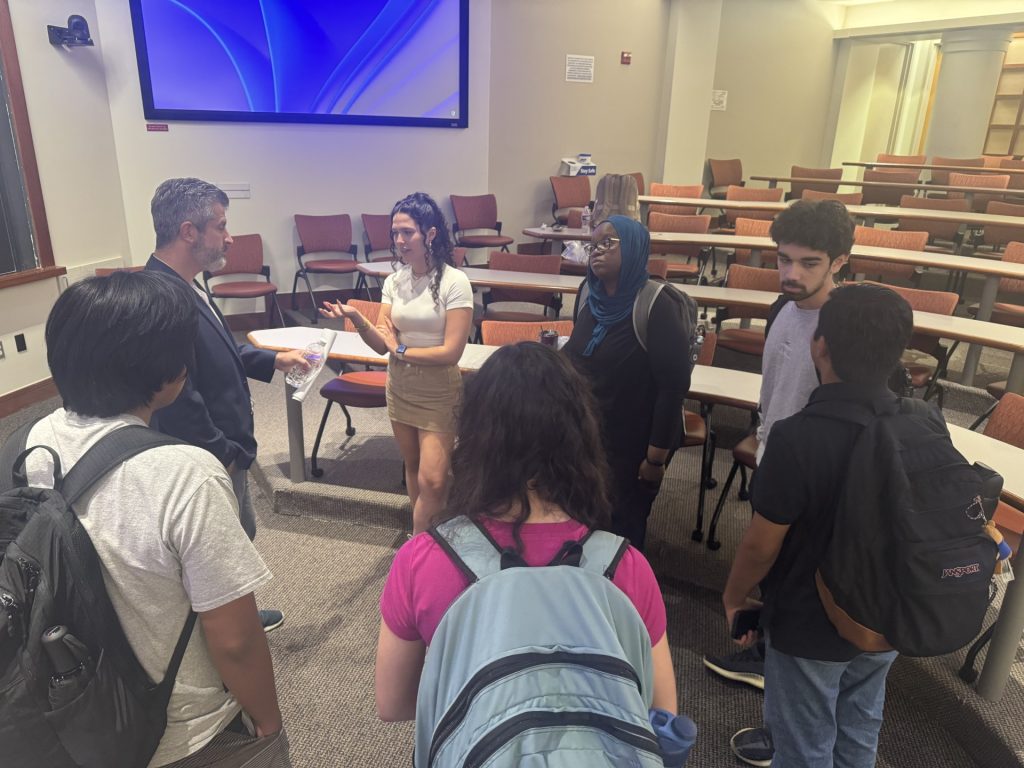 A group of student standing in a circle talking