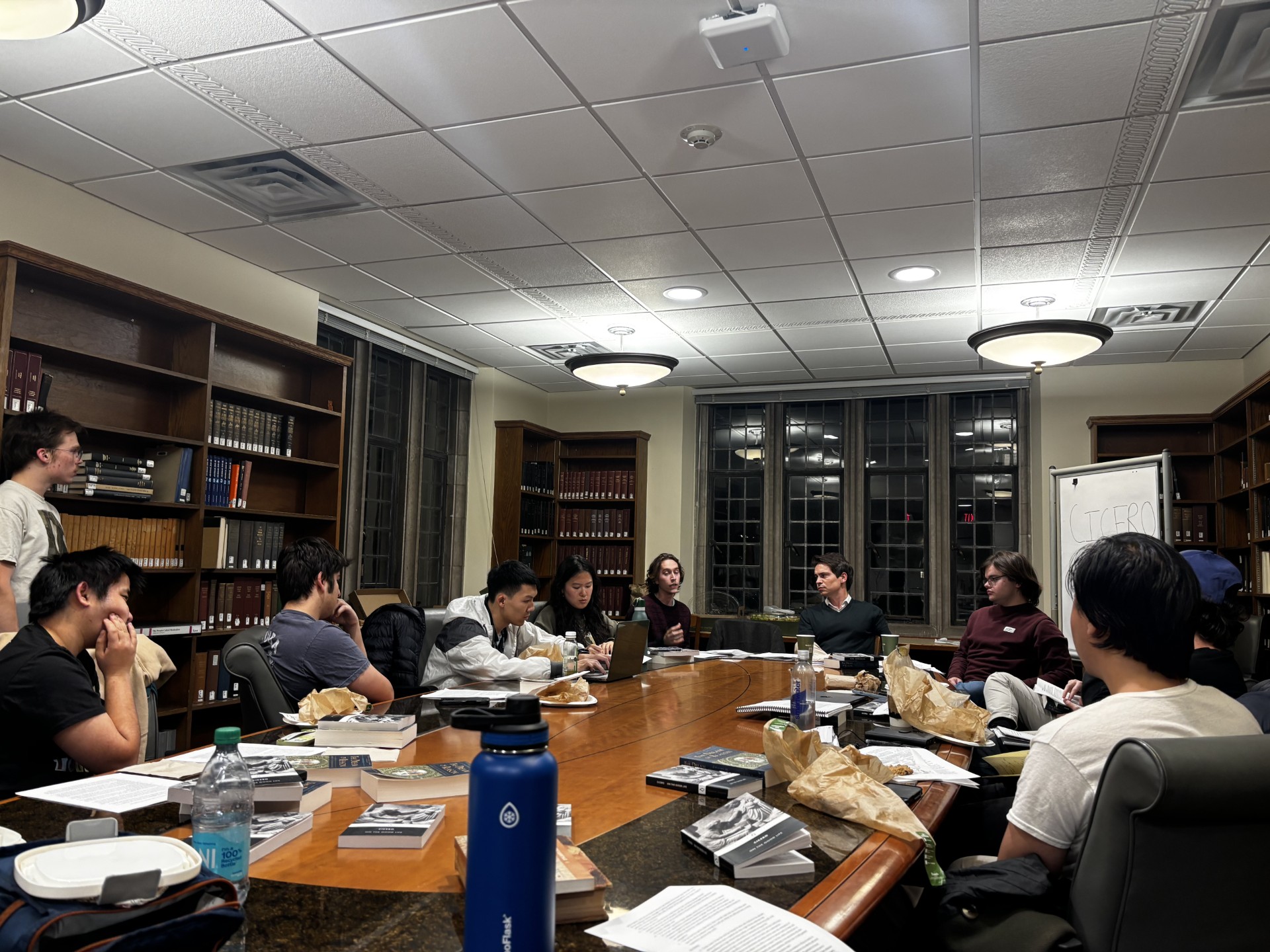 Group of Students sitting at a table with a Professor