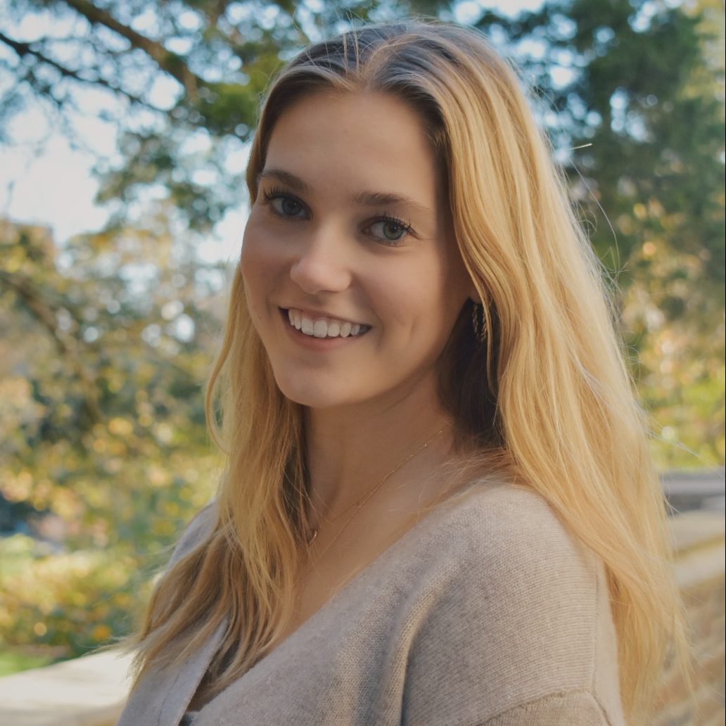 Girl with long blonde hair smiling at the camera