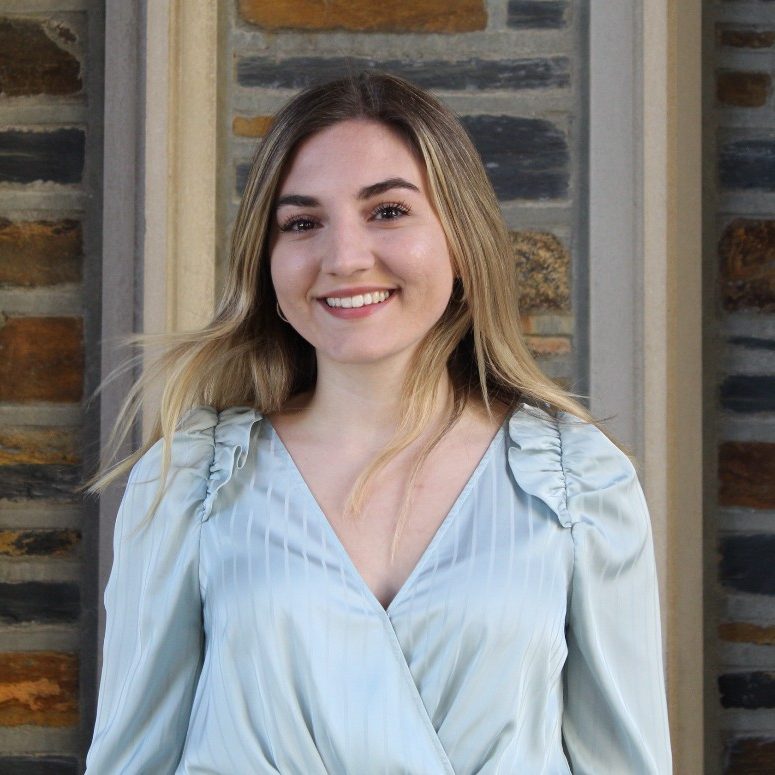 Girl with shoulder length Blonde hair smiling at the camera